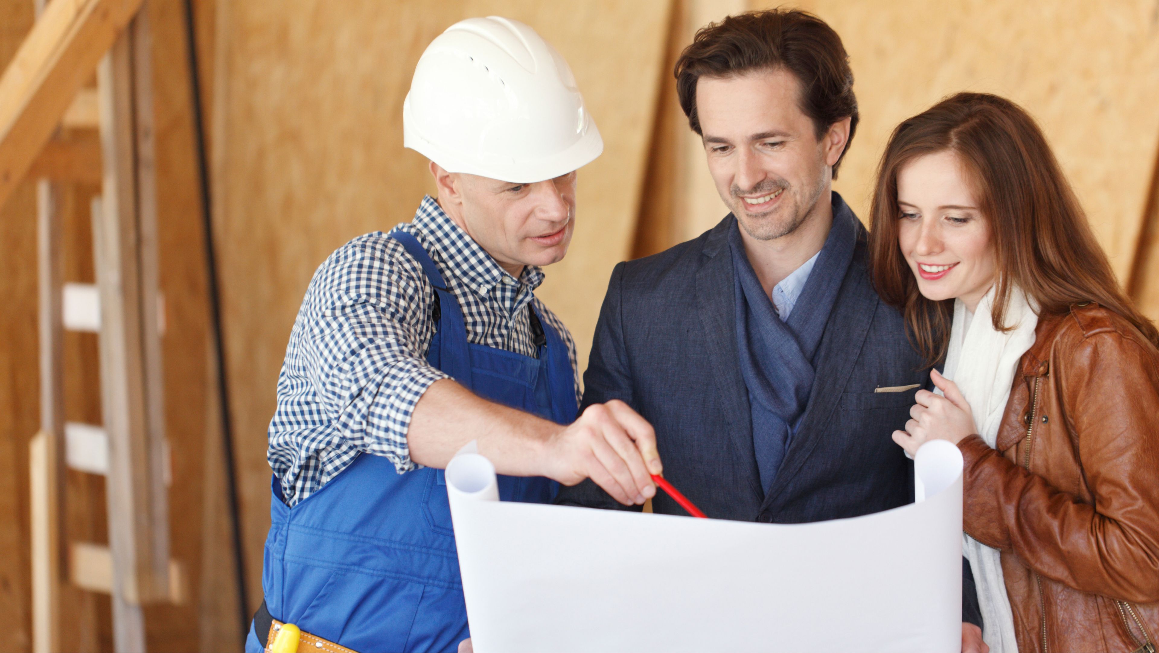 Couple And Contractor Reviewing House Plans